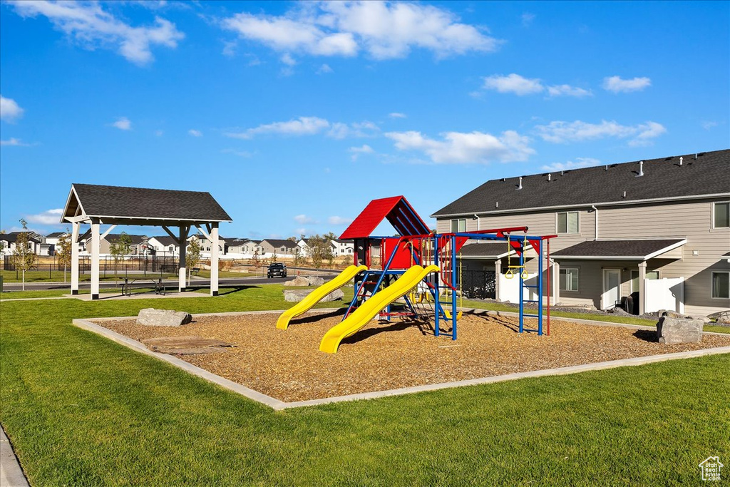 View of jungle gym featuring a lawn