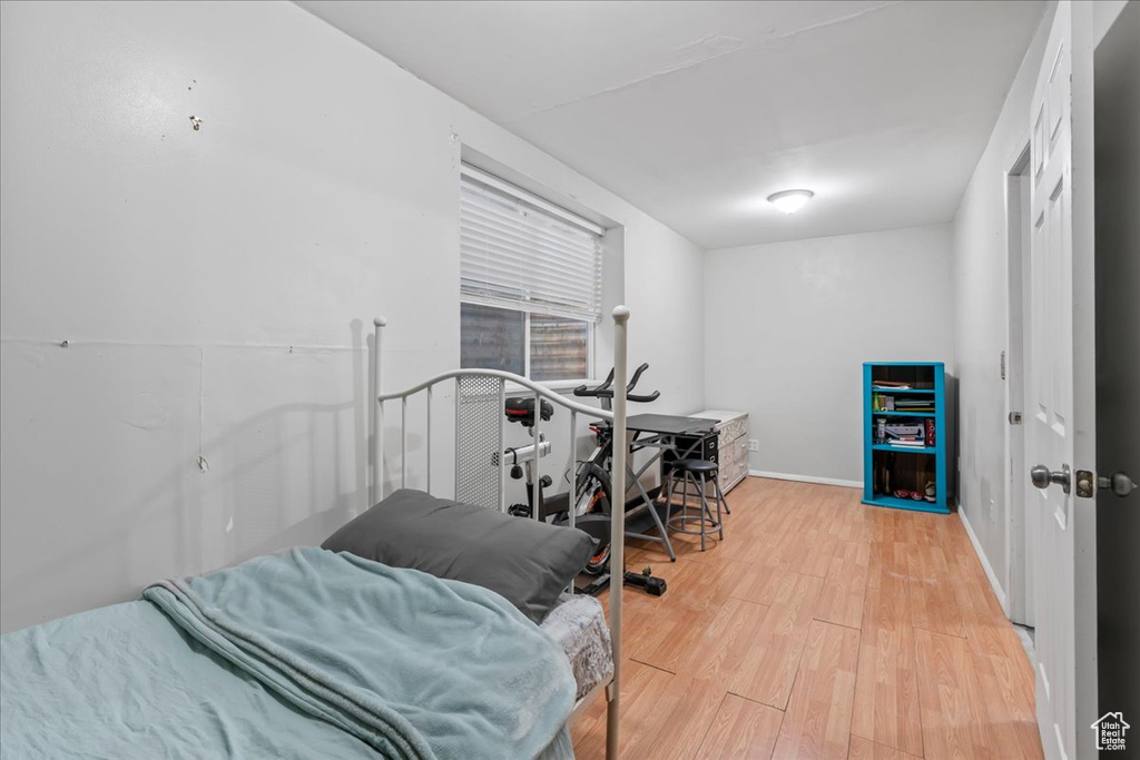 Bedroom with light hardwood / wood-style floors