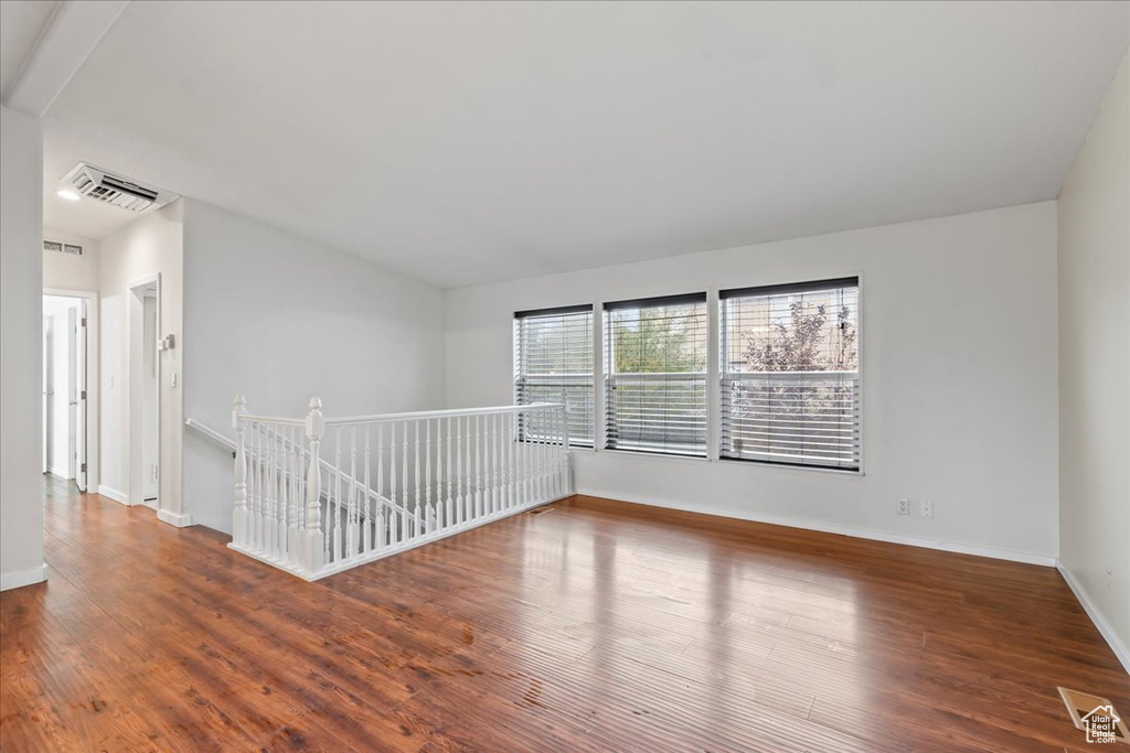 Unfurnished room with dark hardwood / wood-style floors