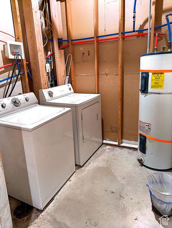 Clothes washing area featuring washer and clothes dryer and water heater