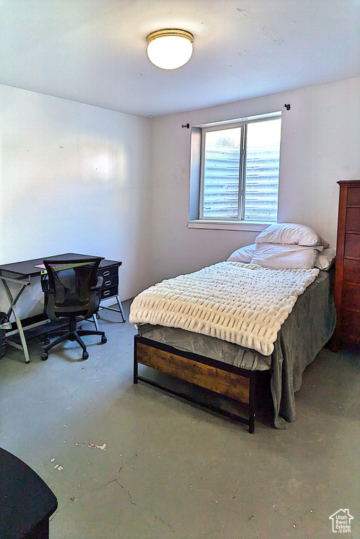 Bedroom featuring concrete floors