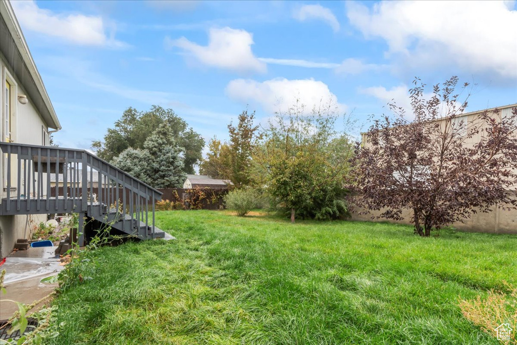 View of yard with a wooden deck