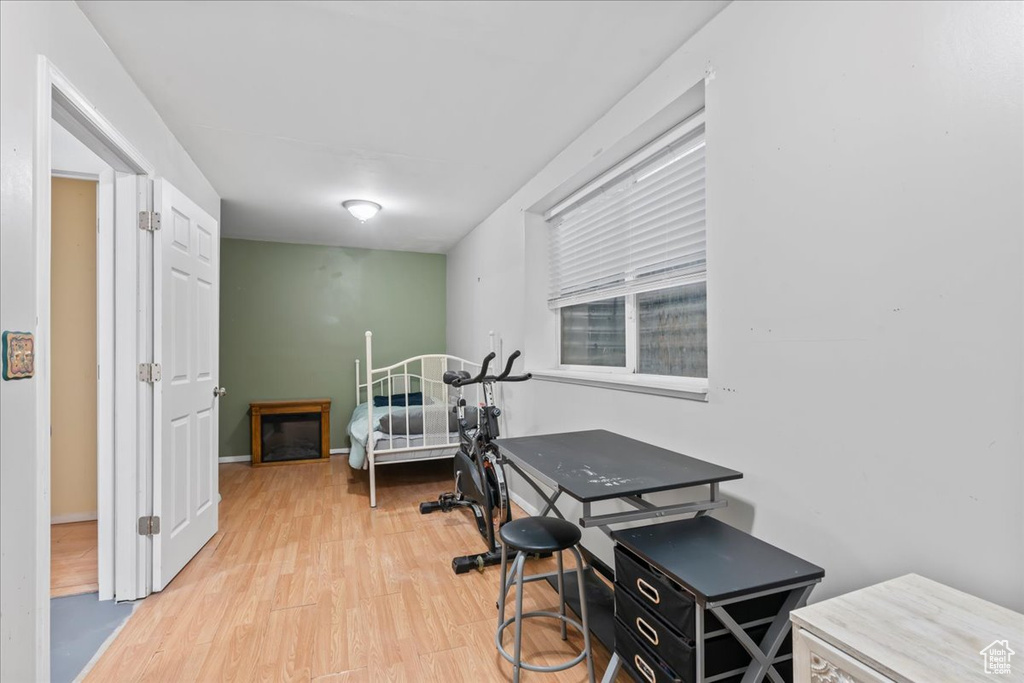 Workout room with light hardwood / wood-style flooring