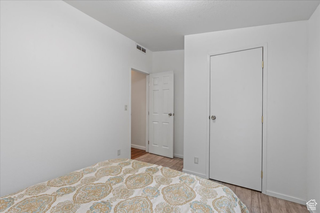 Unfurnished bedroom with a closet and light wood-type flooring