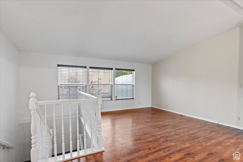 Unfurnished room featuring dark hardwood / wood-style floors