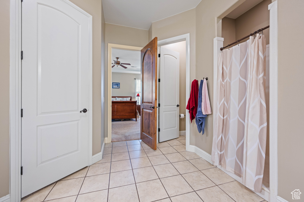 Bathroom featuring tile patterned floors and ceiling fan