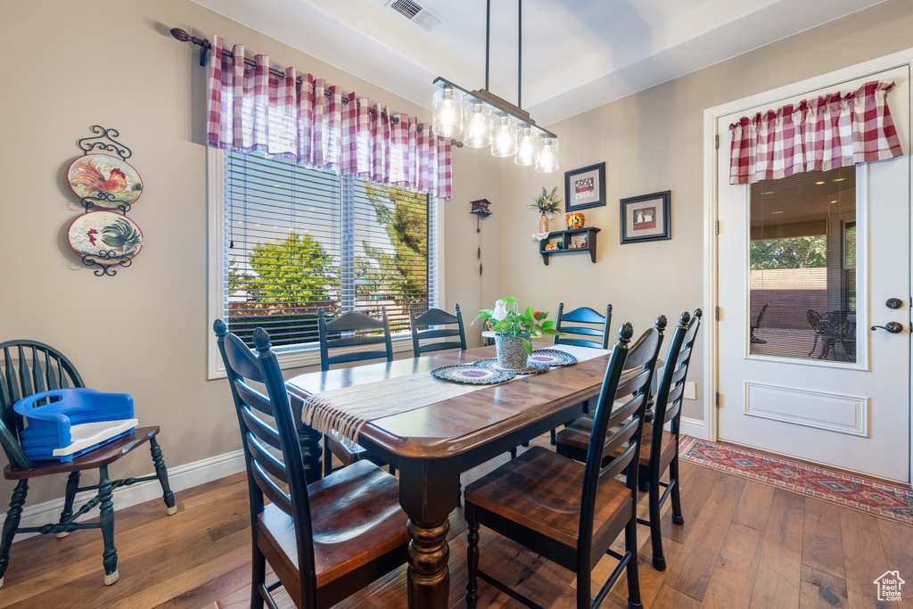 Dining room featuring hardwood / wood-style flooring and plenty of natural light