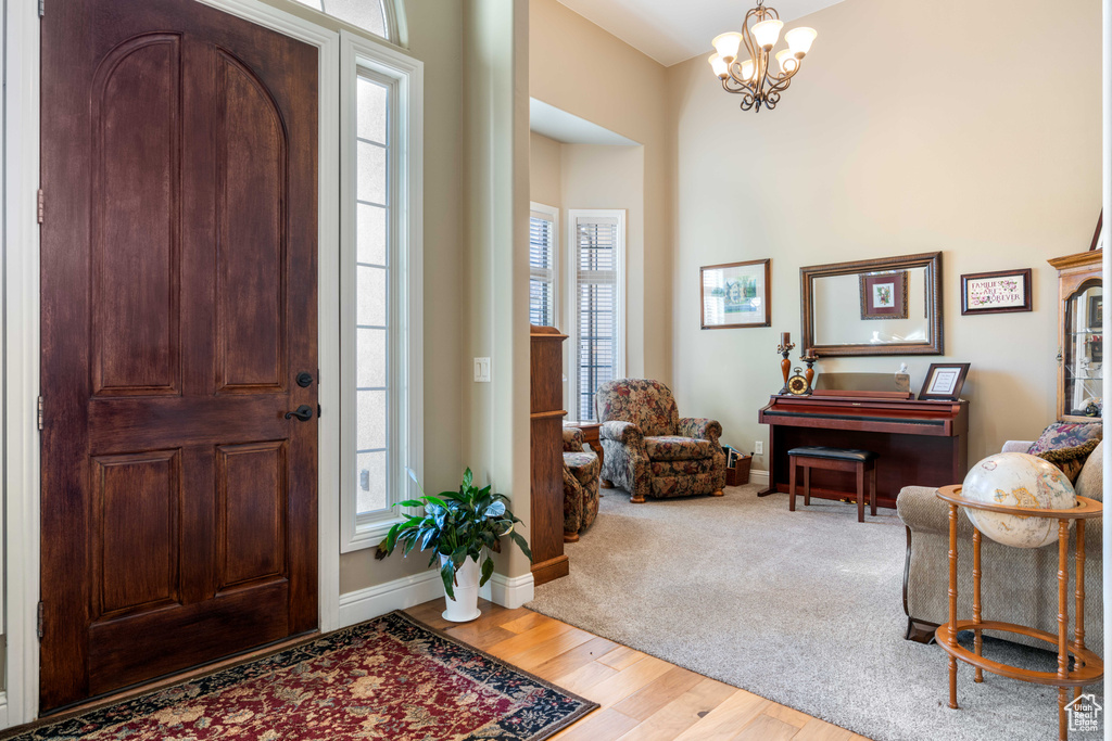 Entrance foyer featuring hardwood / wood-style floors, a chandelier, and plenty of natural light