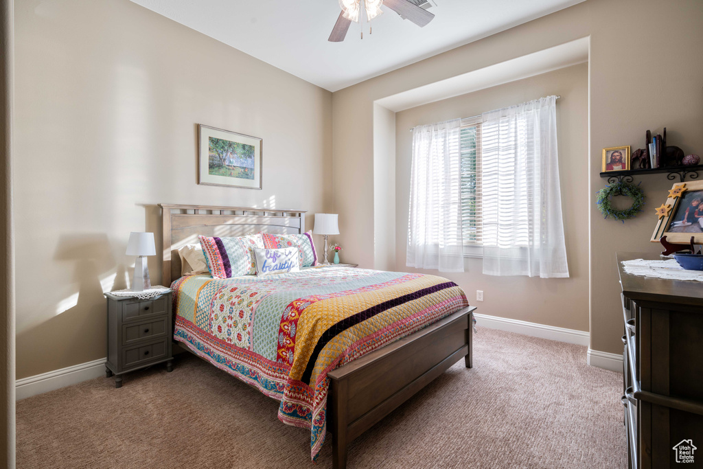 Carpeted bedroom with ceiling fan