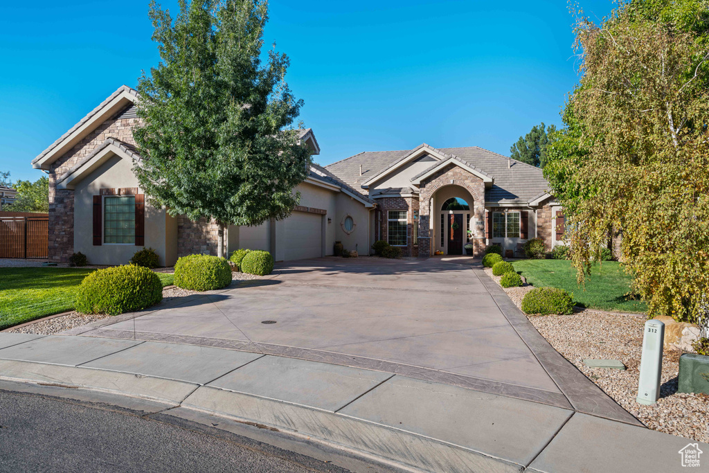 View of front of home featuring a front yard and a garage