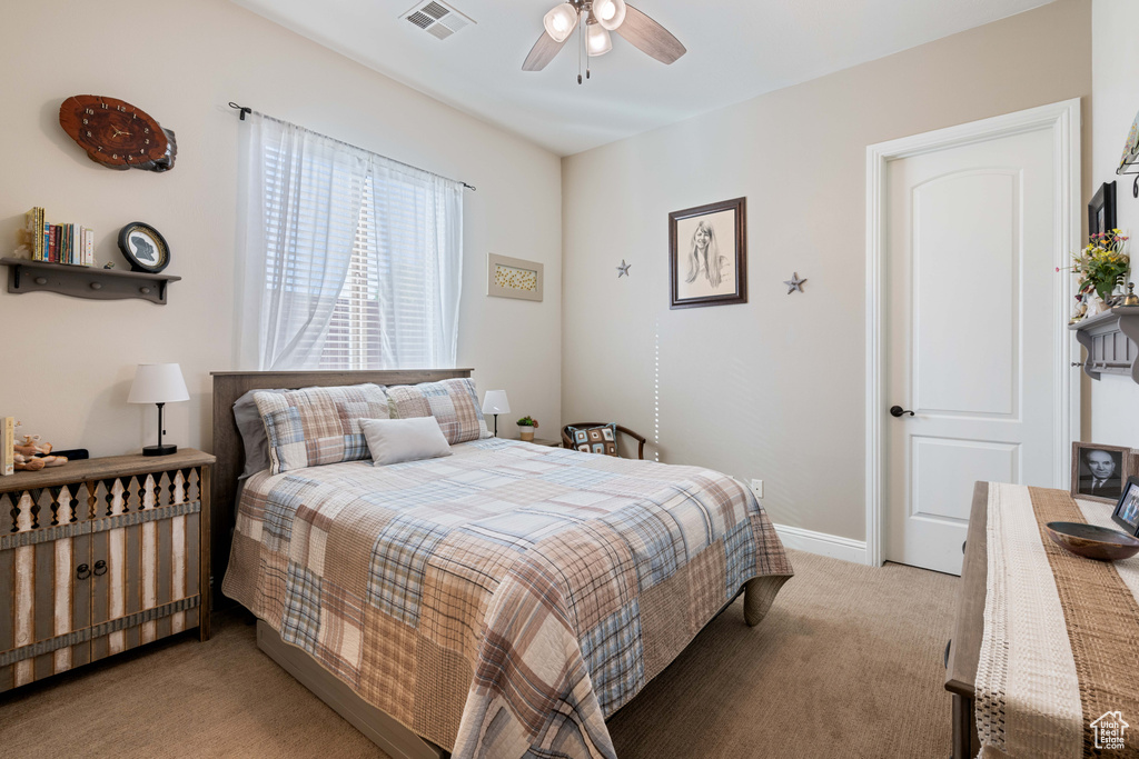 Bedroom featuring light carpet and ceiling fan