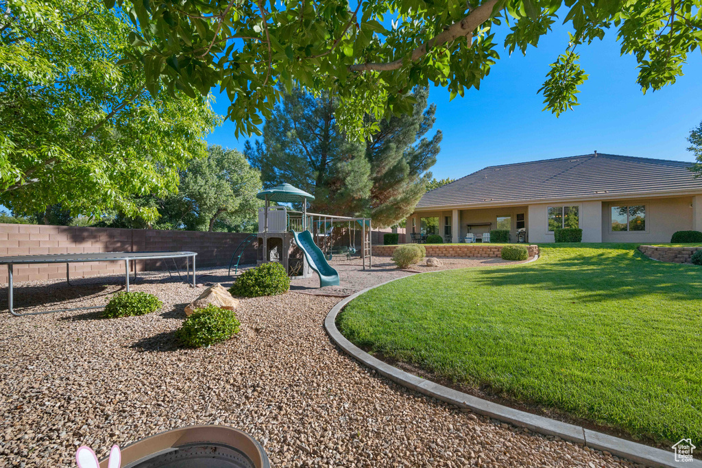 View of jungle gym featuring a lawn