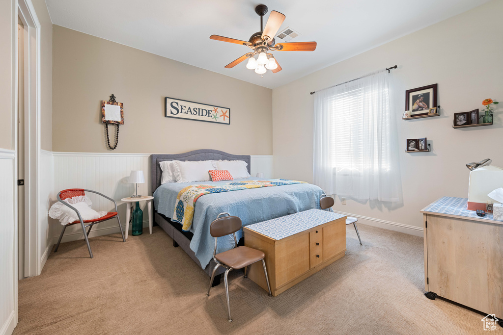 Bedroom featuring light colored carpet and ceiling fan