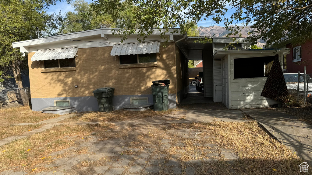 Back of property with a mountain view