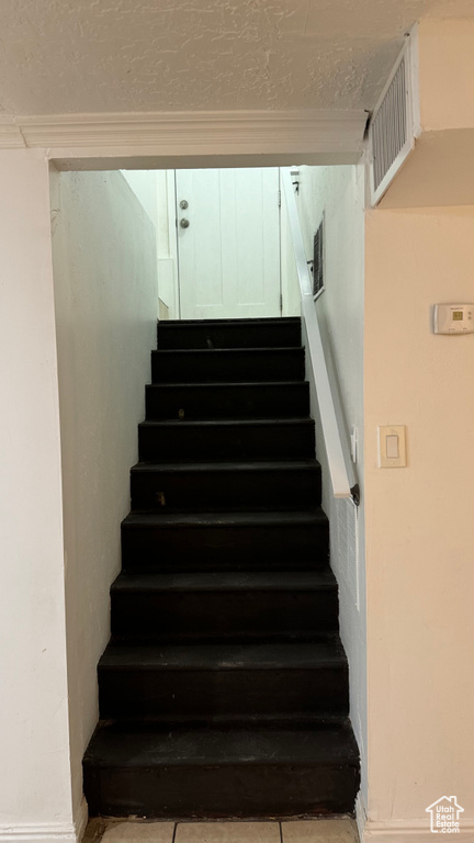 Staircase with tile patterned flooring