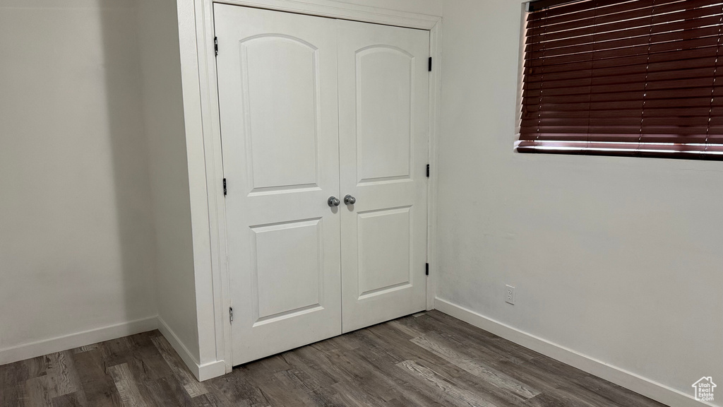 Unfurnished bedroom with hardwood / wood-style floors and a closet