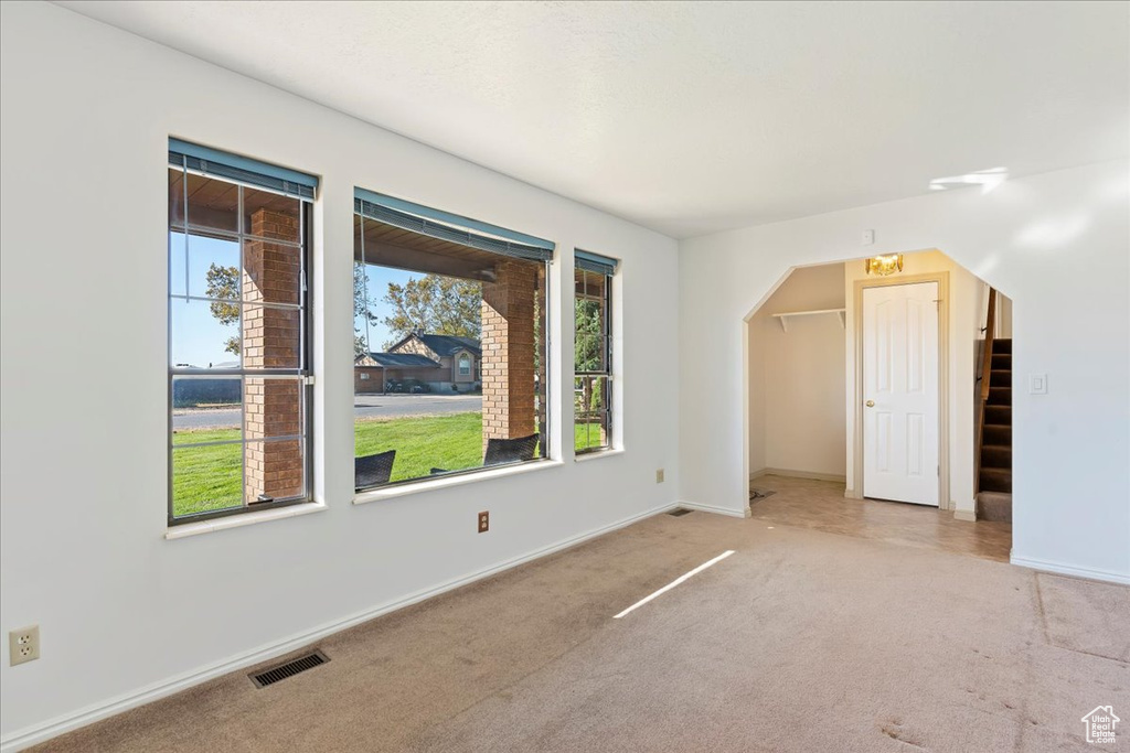 Bonus room featuring light colored carpet