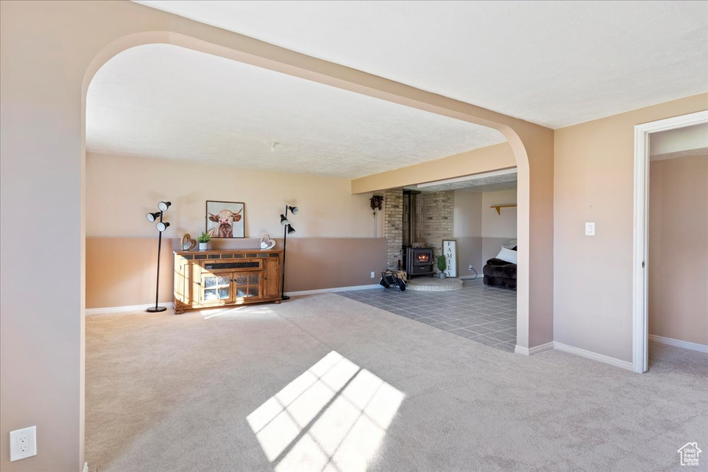 Interior space with a wood stove and carpet floors