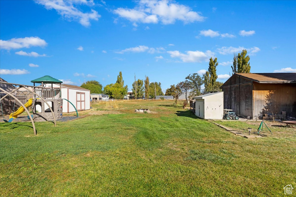 View of yard featuring a shed and a playground