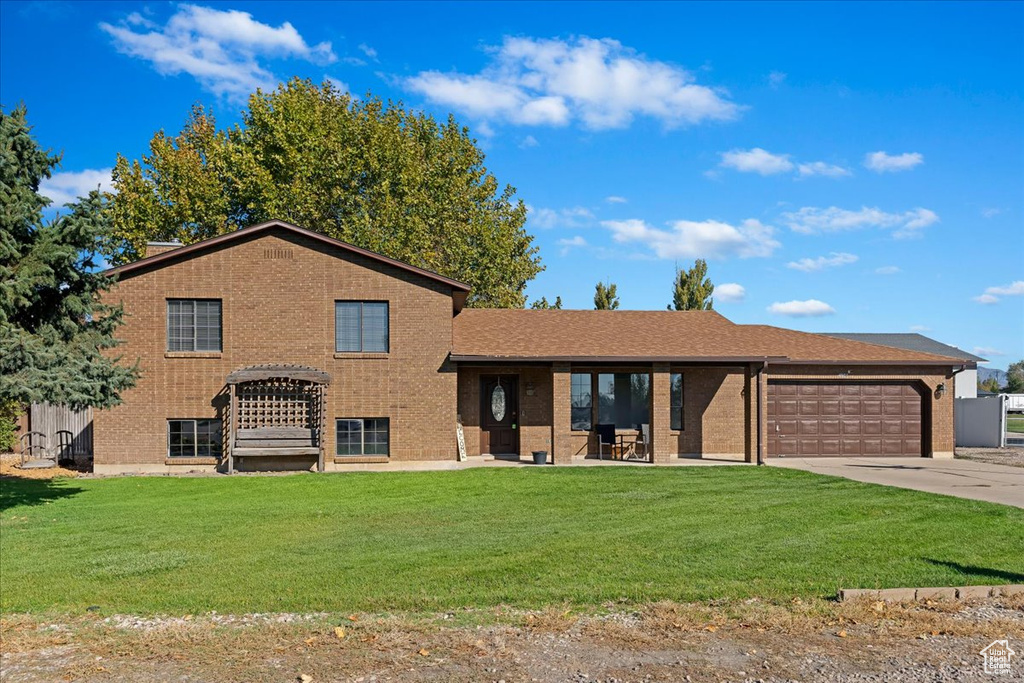 Split level home with a front yard and a garage