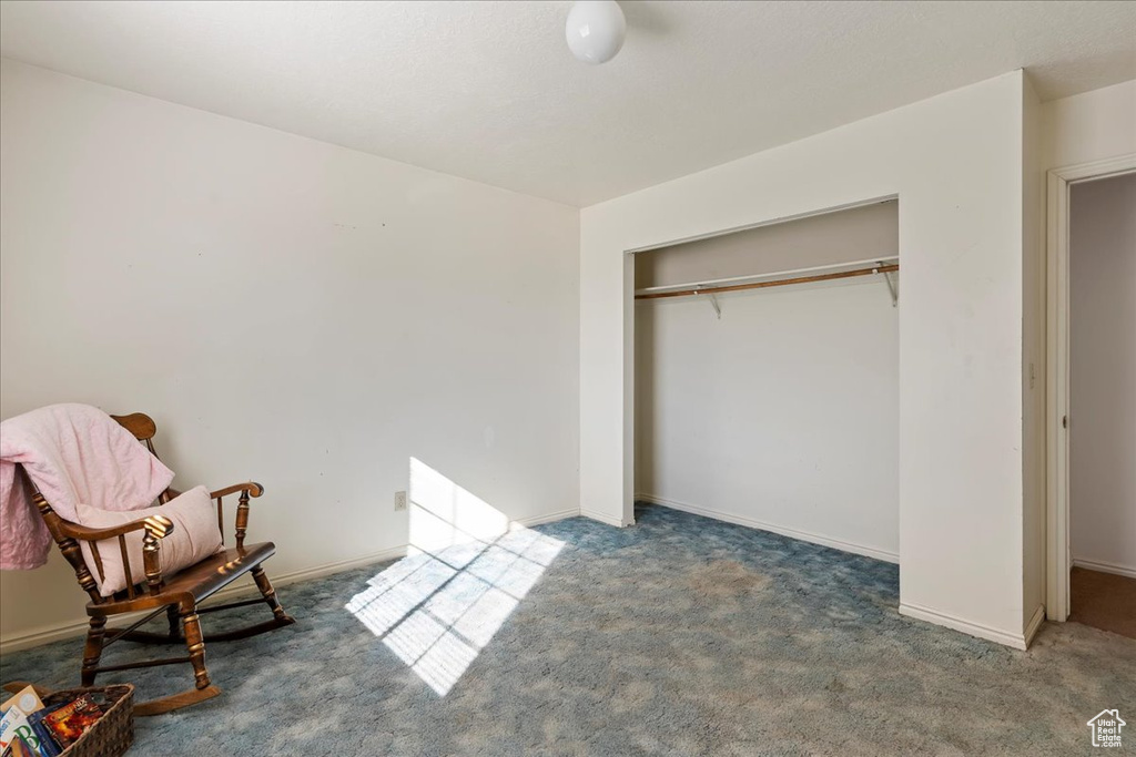 Carpeted bedroom with a closet