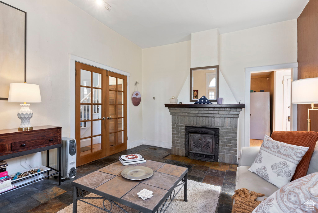 Living room featuring french doors and a brick fireplace