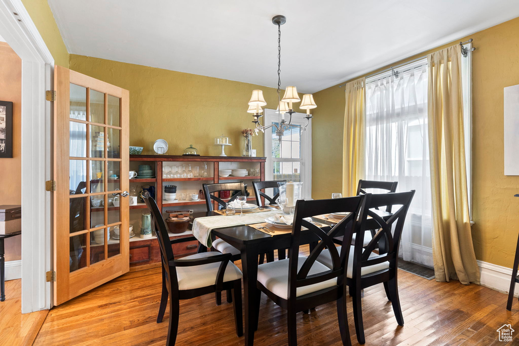 Dining room featuring an inviting chandelier and wood-type flooring