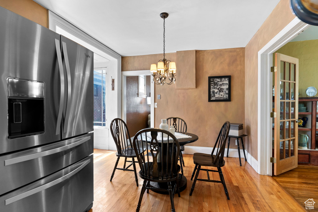 Dining room featuring a chandelier and light wood-type flooring