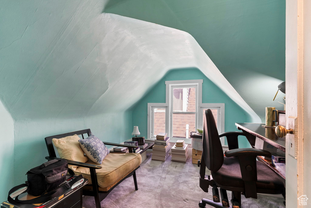 Carpeted office featuring lofted ceiling