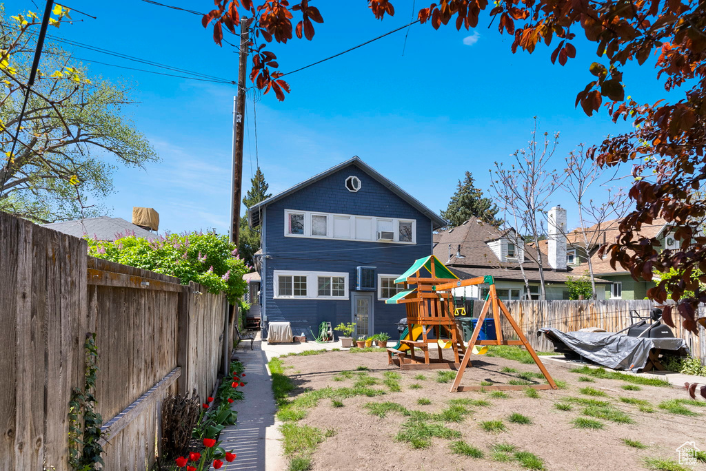 Back of property with a playground