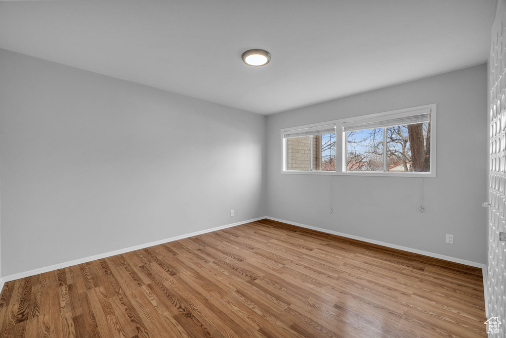 Empty room with light hardwood / wood-style floors