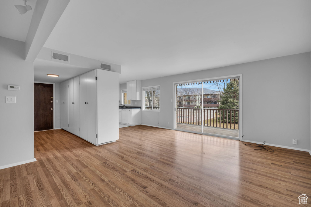 Unfurnished living room featuring light hardwood / wood-style flooring