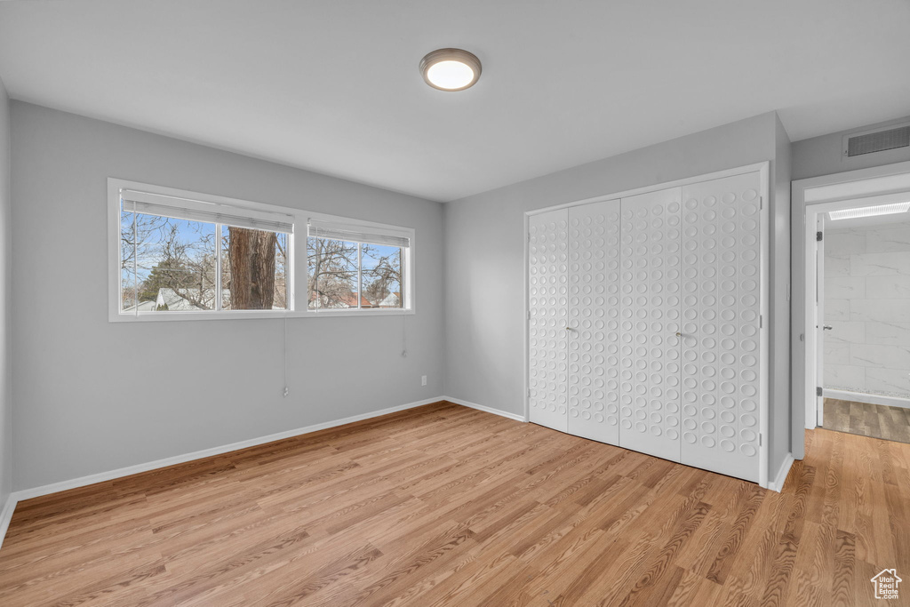 Unfurnished bedroom with light wood-type flooring