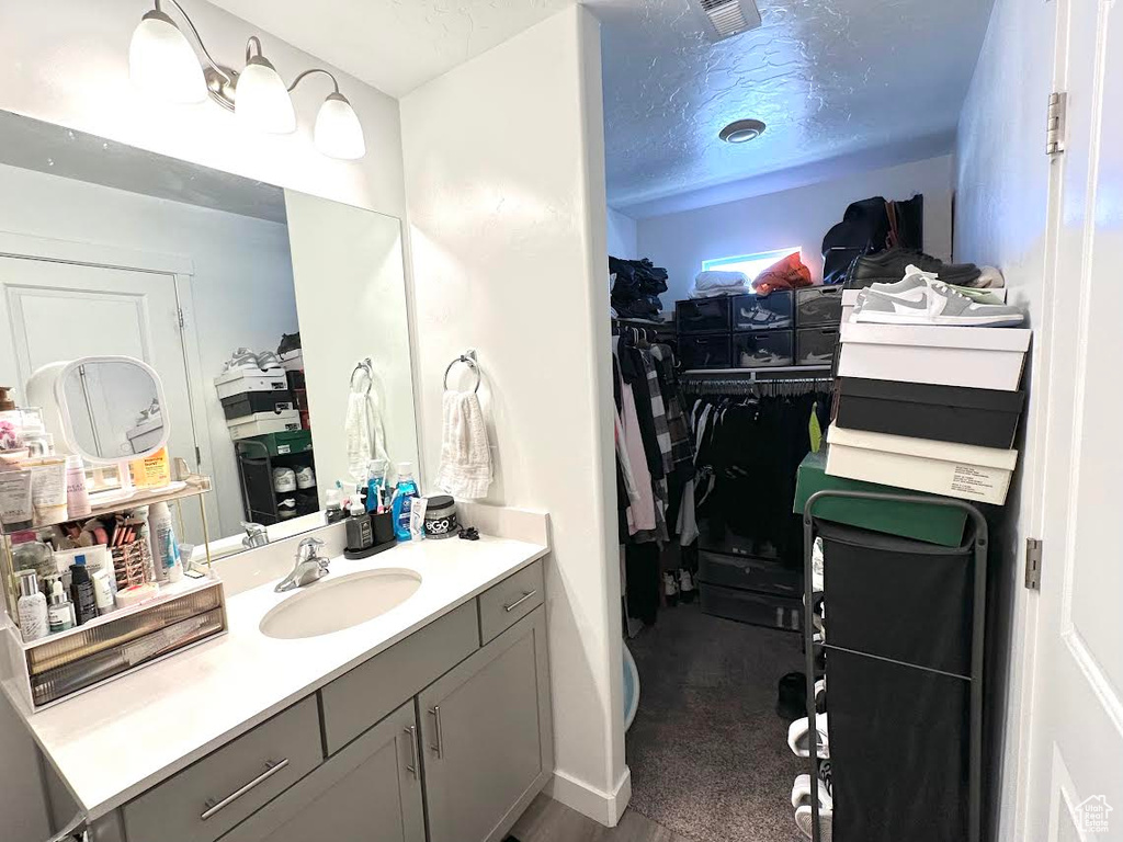 Bathroom with vanity and a textured ceiling