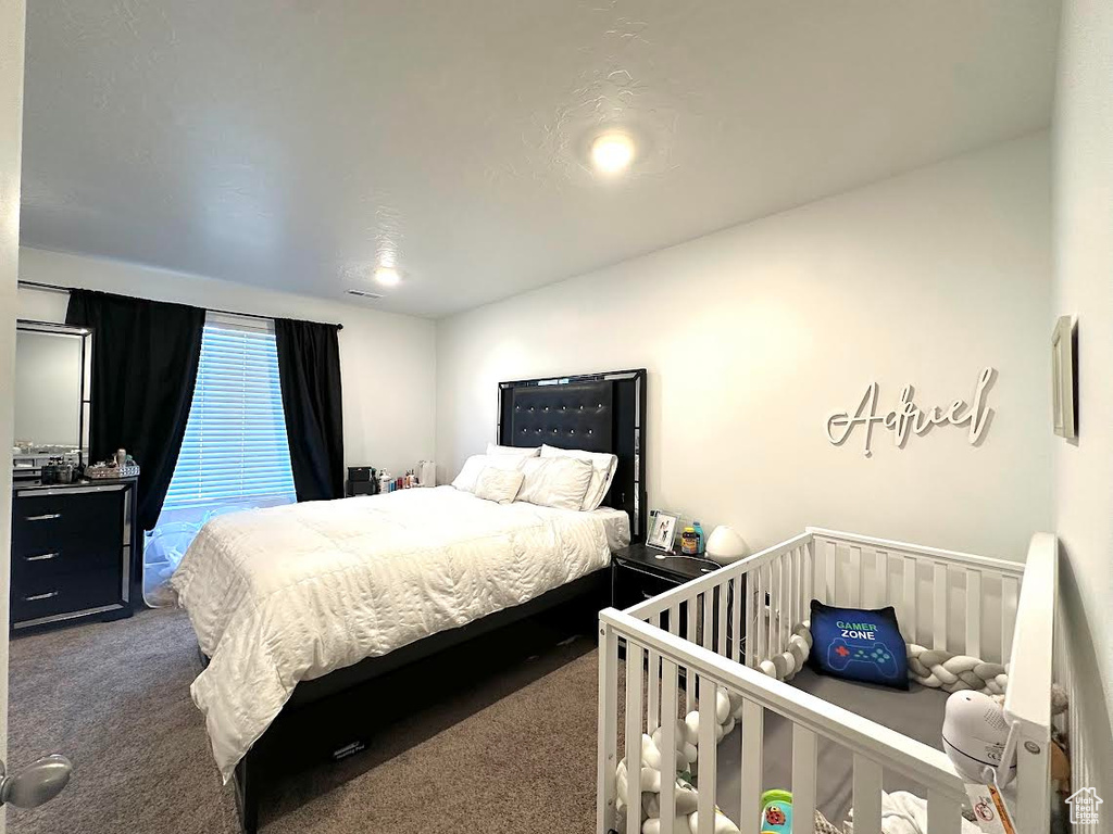 Bedroom with dark carpet