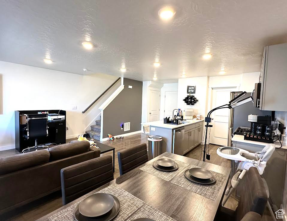 Dining space featuring a textured ceiling and sink