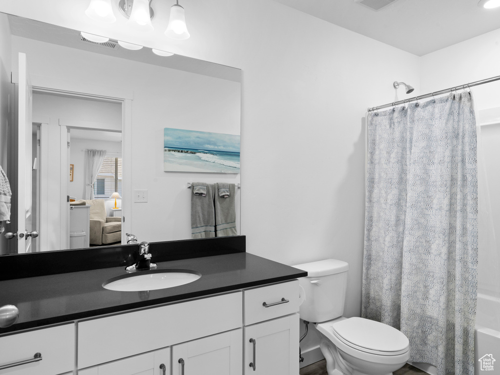 Full bathroom with vanity, toilet, and shower / tub combo