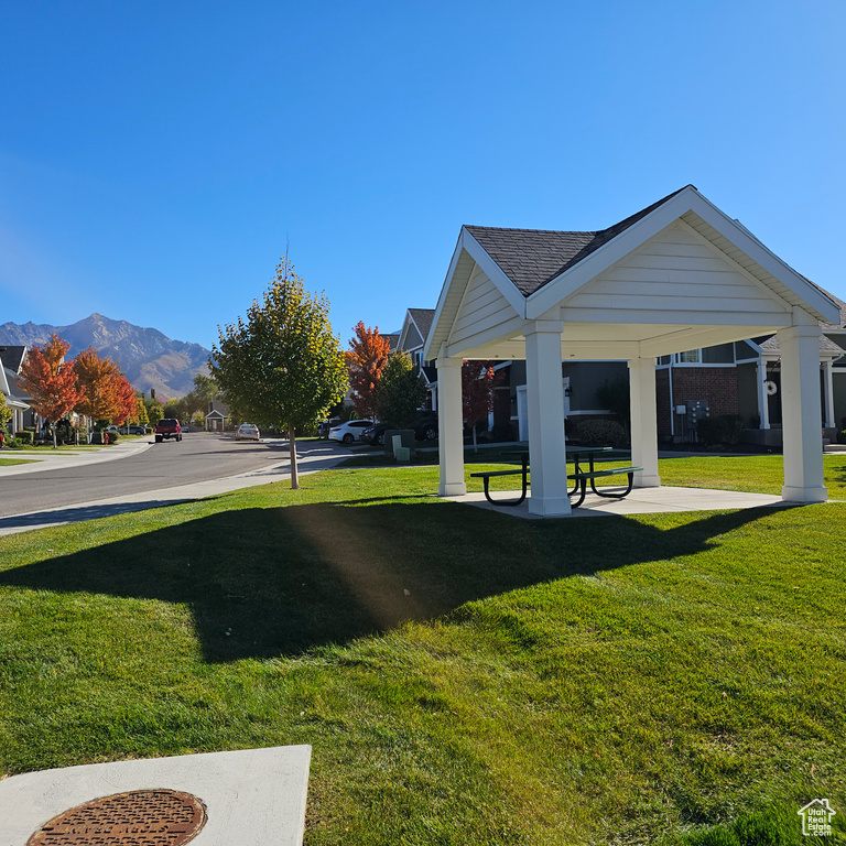 View of property\\\'s community featuring a mountain view and a lawn