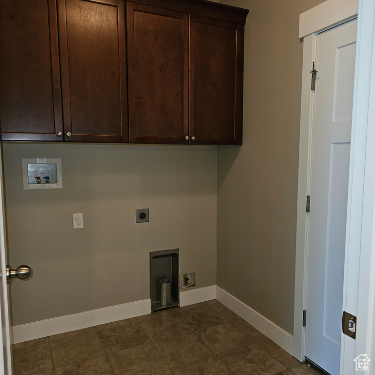 Clothes washing area featuring cabinets, washer hookup, and electric dryer hookup