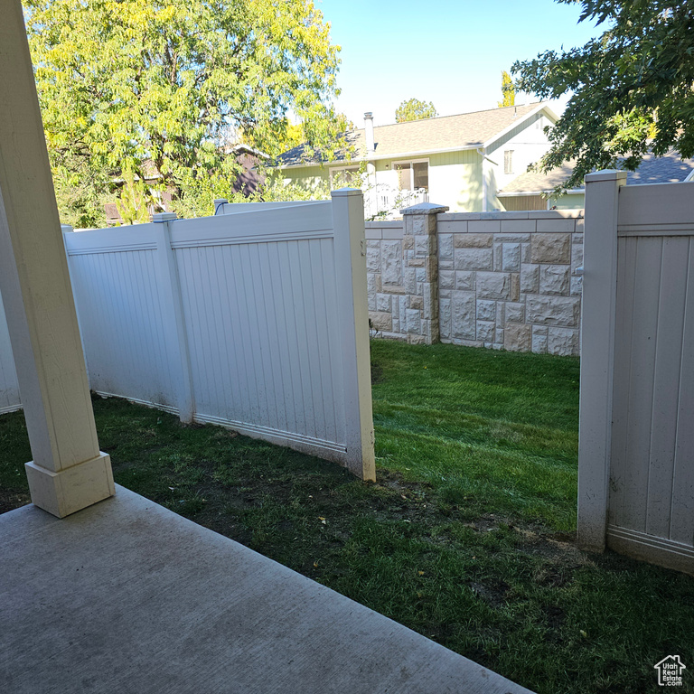 View of gate with a lawn