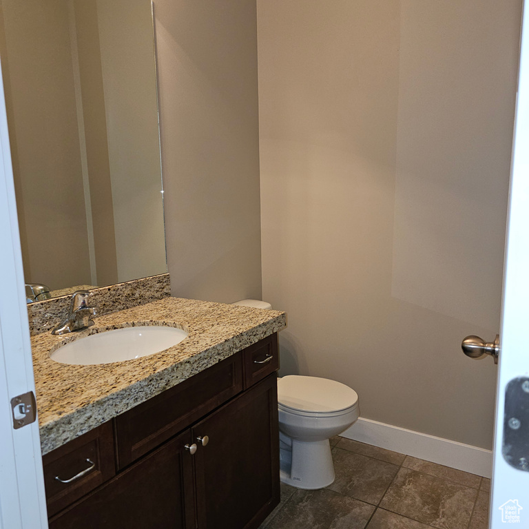 Bathroom with vanity, toilet, and tile patterned floors