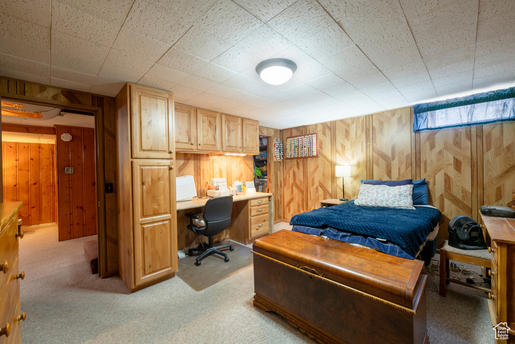 Carpeted bedroom with wood walls