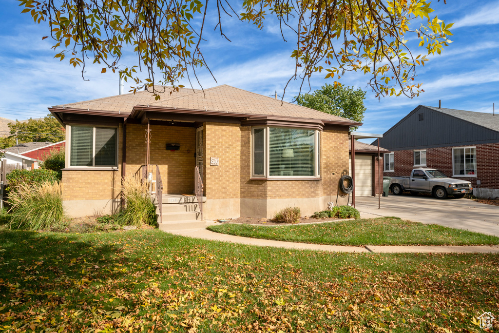 Bungalow-style home featuring a front lawn