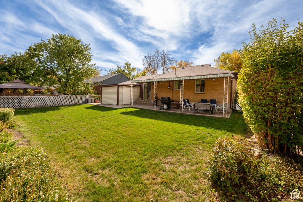 Back of house featuring a patio and a lawn