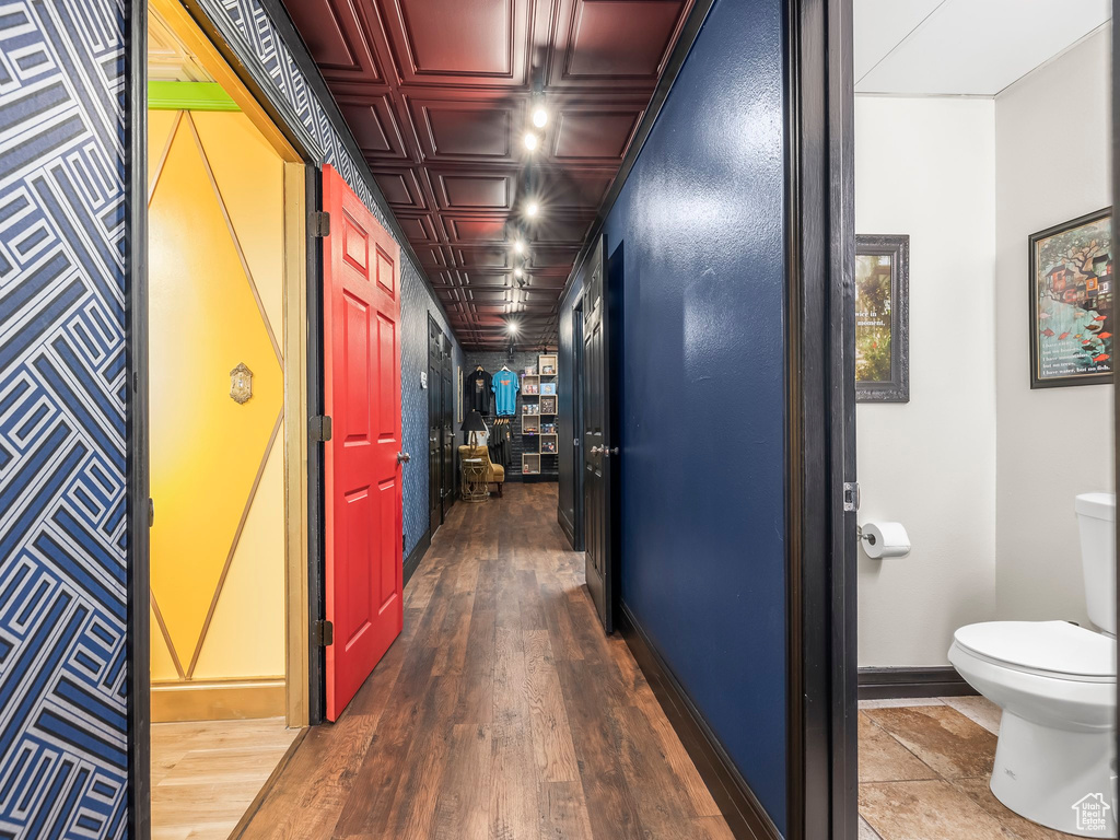 Corridor with dark hardwood / wood-style flooring