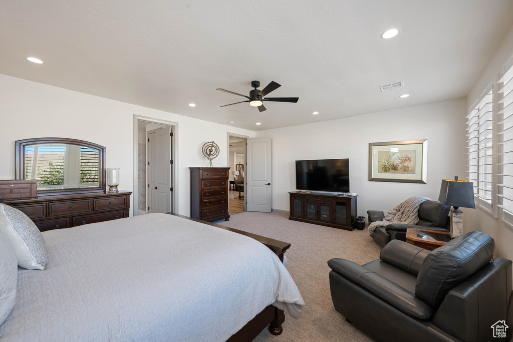 Carpeted bedroom featuring ceiling fan