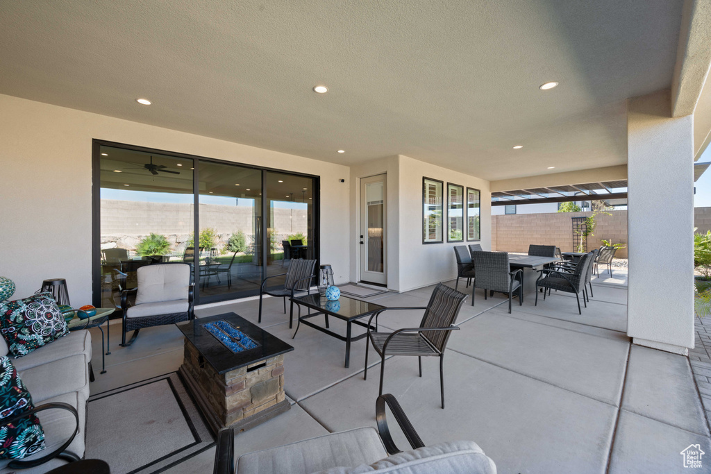 View of patio / terrace featuring an outdoor living space with a fire pit