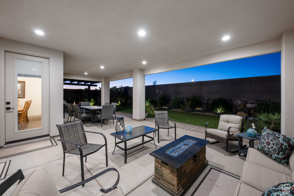 View of patio with an outdoor living space with a fire pit