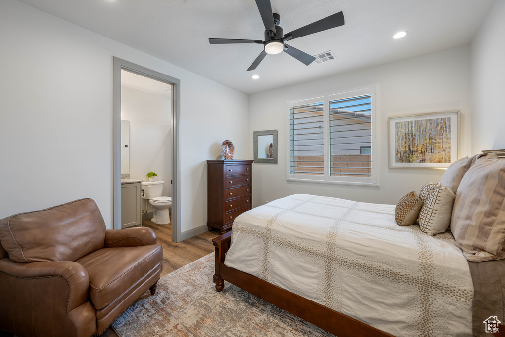 Bedroom with connected bathroom, light hardwood / wood-style flooring, and ceiling fan