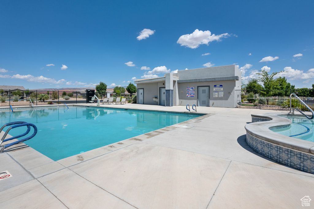 View of pool with a patio and a jacuzzi